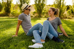 young couple sitting at park enjoying a healthy lifestyle