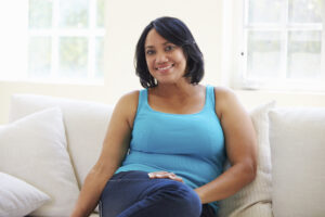 woman sitting on couch with pcos